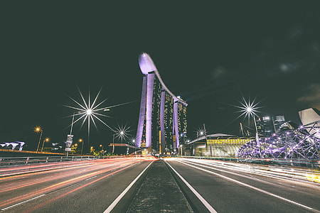 time lapse photography at center island of highway next to Marina Bay Sands during night time thumbnail