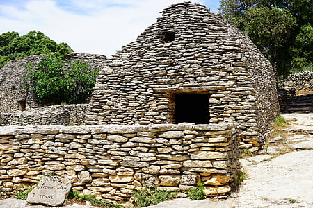 landscape photo of brown stone house beside trees thumbnail