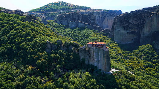 brown and white house on mountain cliff thumbnail