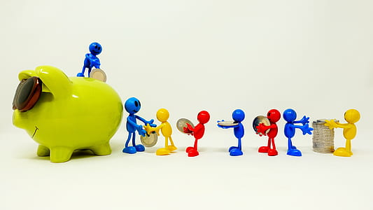 green ceramic coin bank on white surface thumbnail