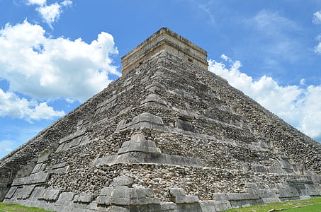 brown and gray concrete pyramid under white cloudy sky thumbnail