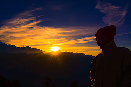 Silhouette of Person Near Mountain during Golden Hour thumbnail