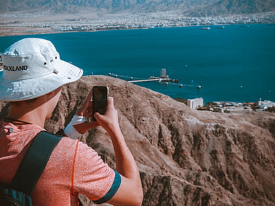 man taking photo of ocean thumbnail