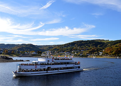 white tourist ship near mountains thumbnail