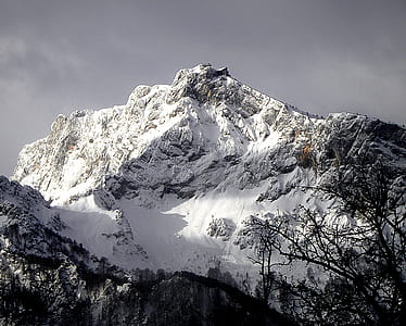 Mountain Cliff Covered With Snow Near Trees Landscape Photo thumbnail