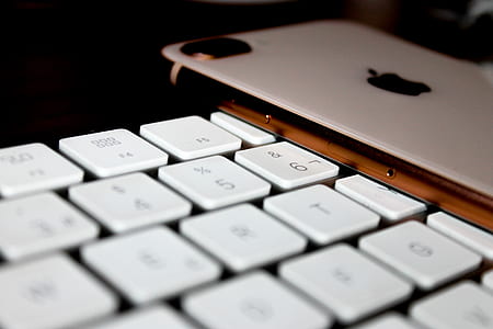 silver iPhone 7 Plus on white computer keyboard thumbnail