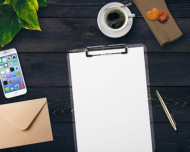 white printer paper beside cup of coffee on black surface thumbnail