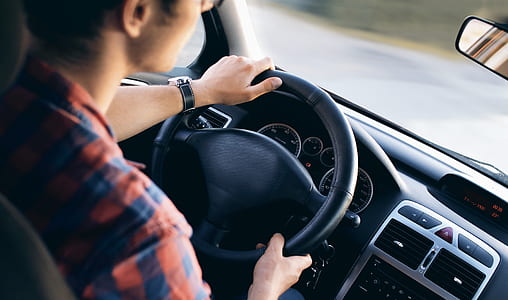 selective focus photography of man driving vehicle thumbnail