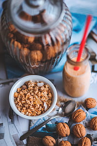 bowl of cereals near glass bottle with red straw thumbnail