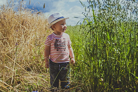 toddler walking in grass field thumbnail