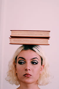 woman balancing two books on her head thumbnail