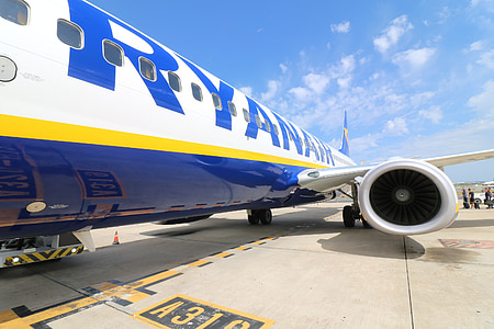 low-angle photo of white, blue, and yellow Ryanair plane parked on pavement thumbnail