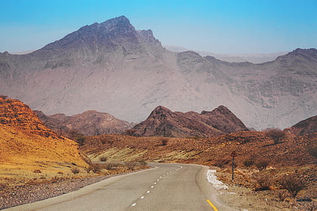 gray concrete pavement distant from mountain thumbnail
