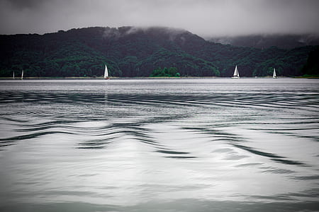 body of water under cloudy sky thumbnail
