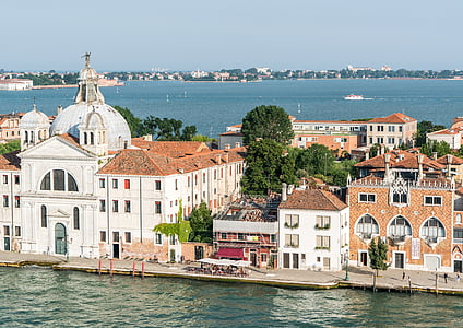 houses surrounded by ocean during daytime thumbnail