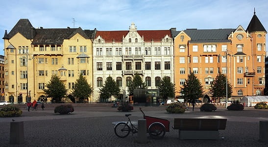 bicycle with cart park beside bench in front buildings thumbnail