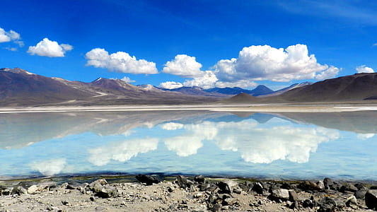 large body of water near mountains thumbnail