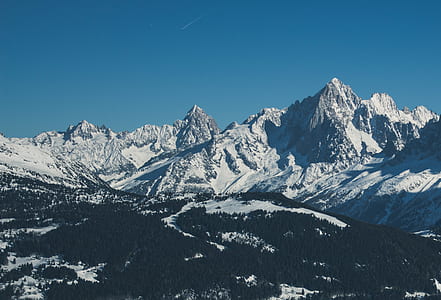 snow covered mountain under white and blue sky thumbnail