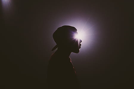 silhouette photography of man wearing hat thumbnail