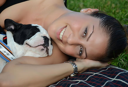 Boston Terrier sleeping on woman's shoulder at daytime thumbnail
