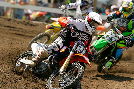 man riding motocross dirt bike on track at daytime thumbnail