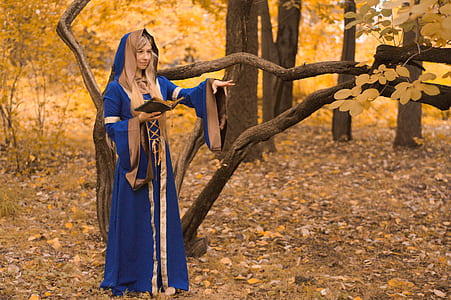 woman dressed as a wizard in the forest casting a spell thumbnail