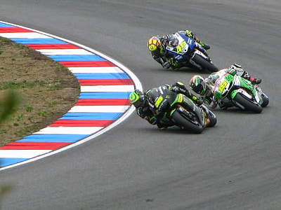 three Moto GP racers racing at the corner apex thumbnail