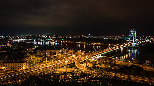 brown buildings with lights at nighttime thumbnail