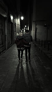 grayscale photography of couple walking on sidewalk thumbnail