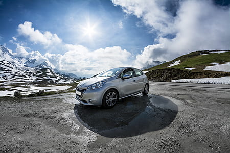 silver Peugeot 208 in a distance of snow field thumbnail