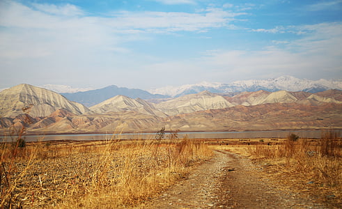 gray road near mountains during daytime photography thumbnail