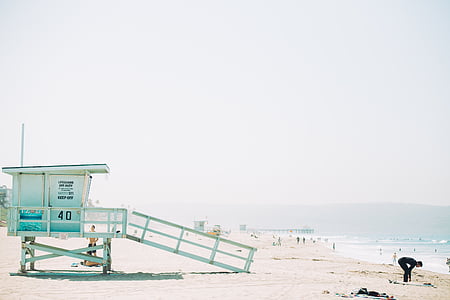 white wooden lifeguard shed near seashore at daytime thumbnail