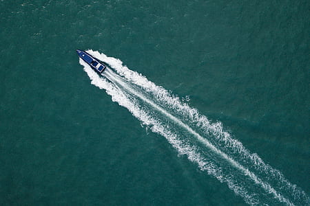 blue motorboat on body of water thumbnail