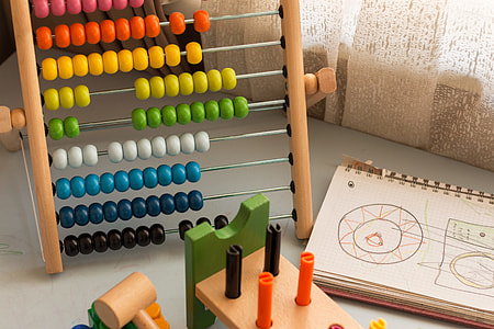 multi-colored abacus beside printed notebook thumbnail