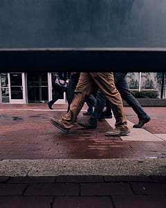 person walking on brown brick floor thumbnail