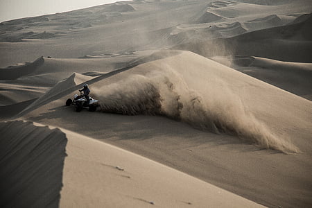 person riding white ATV on desert thumbnail