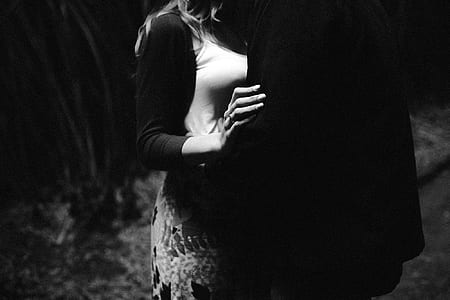 woman in black cardigan beside man in black suit thumbnail