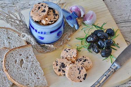 sliced bread on chopping board besides jar, onion, and berries thumbnail