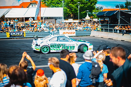 white and green Stock car on field thumbnail