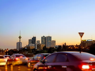 cars on road near high rise building during blue hour thumbnail