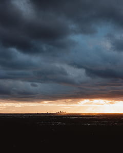 silhouette of city under dark sky thumbnail