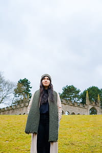 woman wearing gray hat, scarf and pink coat thumbnail