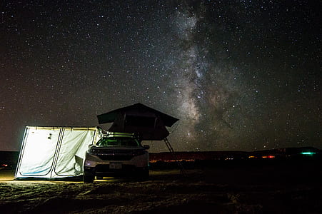 white car beside white tent thumbnail
