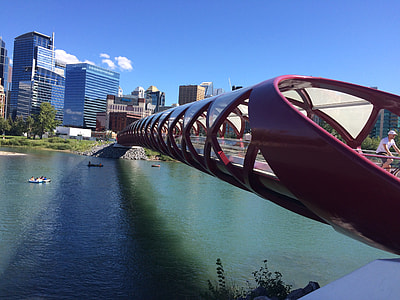 man riding bicycle crossing bridge thumbnail