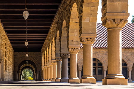 low angle photography of hallway near concrete columns thumbnail