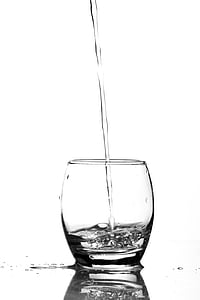 clear liquid pouring on clear drinking glass thumbnail