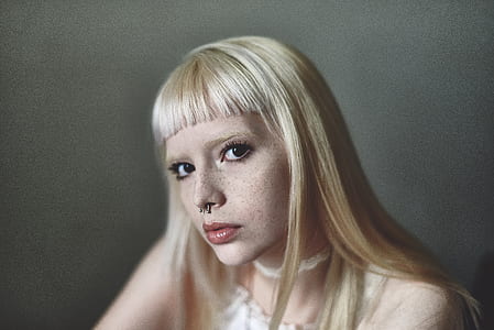 woman wearing white top with nose piercing thumbnail