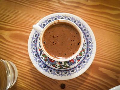 white teacup filled with brown coffee thumbnail