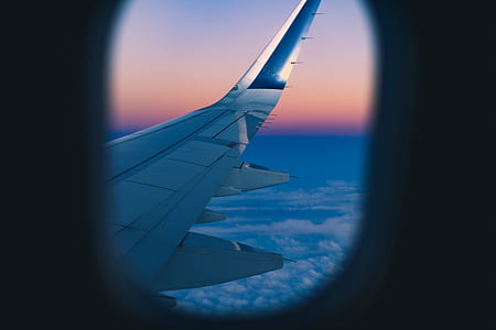 white airplane wing view from inside during golden hour thumbnail