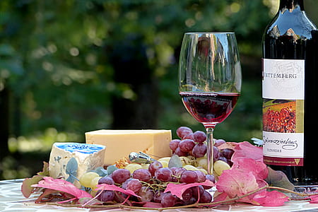 grapes with wine glass and bottle on top of table thumbnail